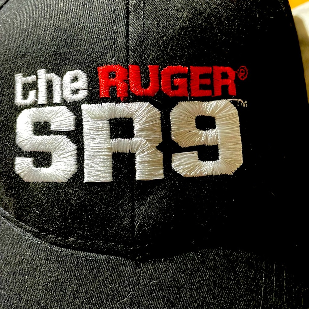 Black Ruder SR9 lid/cap with white trim on bill. Velcro adjustable straps cotton
